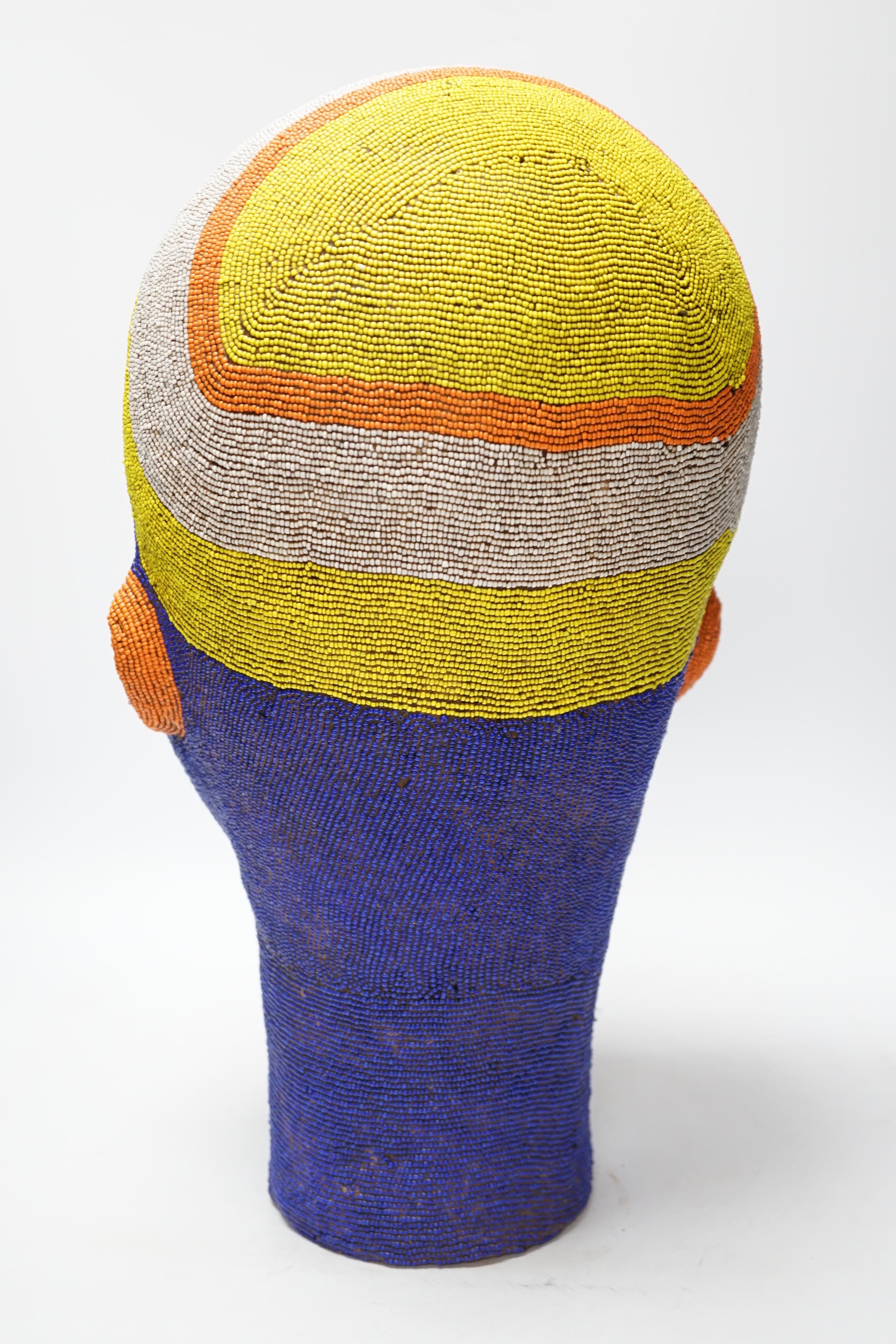 A large African clay multicoloured beadwork head, 48cm high